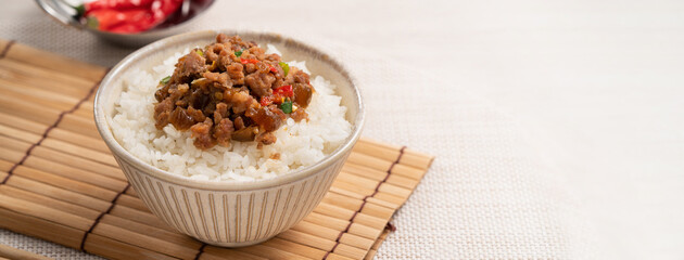 Taiwanese fried minced pork with pickled cucumber on rice named GUA ZI ROU FAN.