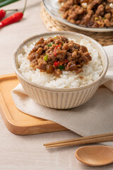 Taiwanese fried minced pork with pickled cucumber on rice named GUA ZI ROU FAN.
