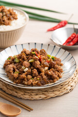 Taiwanese fried minced pork with pickled cucumber on rice named GUA ZI ROU FAN.