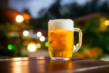 Mug of fresh light beer on the outdoor terrace table