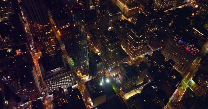Night time at never sleeping New York. Drone footage over the high-rise buildings and marvelous skyscrapers.