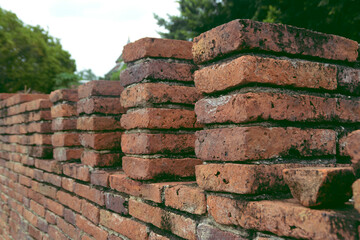 Side of red brick wall and pole.