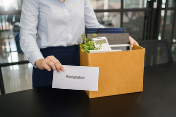 Concept of leaving job, Female employee holding stuff box and sending resignation letter to boss