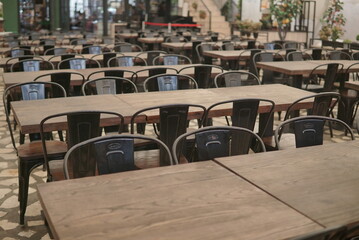 Yogyakarta, indonesia - MAY 26 2022: empty chairs in the restaurant. Restaurant restrictions, pandemic. Furniture, modern restaurant interior. Empty chairs and tables.