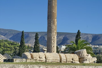 Ancient column, with a toppled column at the base, in a park in Athens, Greece