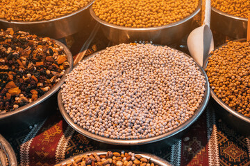 Roasted chickpeas, dried fruits and other nuts on the farmers counter at the local market or oriental bazaar