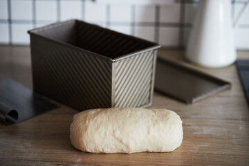 The process of making homemade toast bread in a mold. The concept of healthy homemade food. Front view.