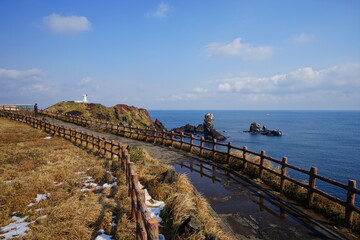 lighthouse and seaside walkway