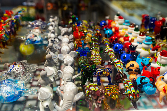 Variety of Murano glass products on shelves of souvenir shop in Venice..