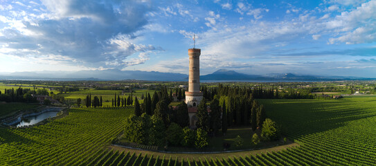 Aerial panorama of Tower of San Martino della Battaglia, Italy. Tower surrounded by vineyards at...