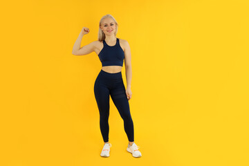 Fototapeta na wymiar Concept of healthy lifestyle with young attractive sporty woman