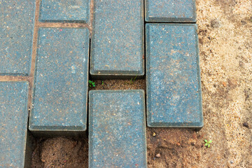 Gray paving slabs at a construction site. Material for paving roads and sidewalks. Close-up. Concrete tiles.