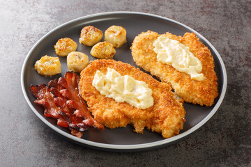 Maryland Fried Chicken With White Gravy served with bananas and bacon close-up in a plate on the table. Horizontal