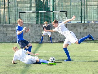 Fototapeta premium Teens playing soccer football match. Competition between two youth soccer teams. Football soccer tournament