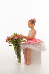 Girl ballerina in a tutu with flowers