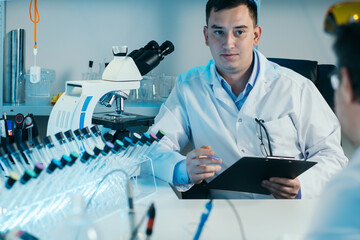 Scientist working with microscope in lab. Laboratory research concept.