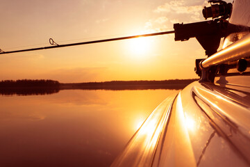 Fishing rod spinning with the line close-up. Fishing rod in rod holder in motor boat due the...