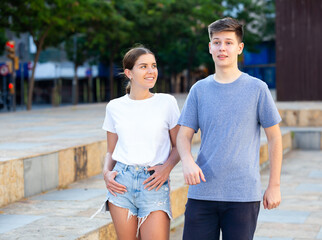 Teenagers are communicating on walk on the street