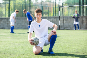 Portrait of teen boy soccer player on the field