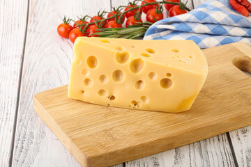 Maasdam cheese piece over board