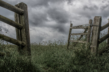 open gate and fence post on grey day