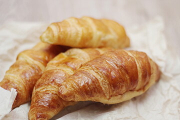 Delicious fresh croissants arranged on a plate
