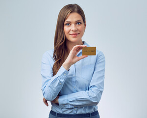 Fototapeta premium Smiling woman bank employee holding credit card. Business woman with long hair wearing blue shirt.
