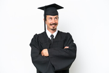Young university graduate man isolated on white background looking up while smiling