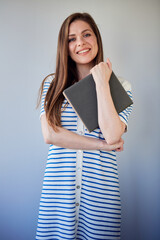 Student girl or teacher woman wearing long white striped dress holding book.