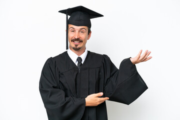 Young university graduate man isolated on white background extending hands to the side for inviting to come