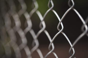 Naklejka premium Closeup fence with metal grid in perspective and blurred.
