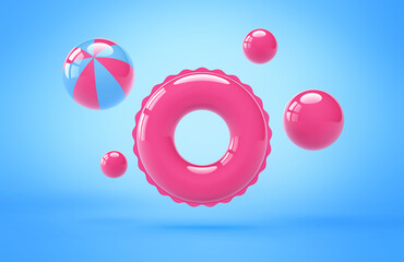 Inflatable pink swimming ring and beach balls on blue background