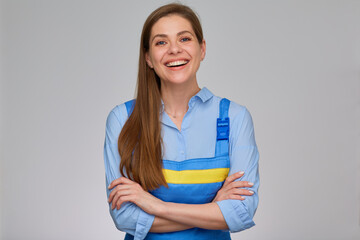 Smiling woman worker plumber or elictrician in blue uniform overalls standing with arms crossed....