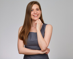 Obraz premium Happy business woman touching her chin and looking away. isolated studio portrait on gray.