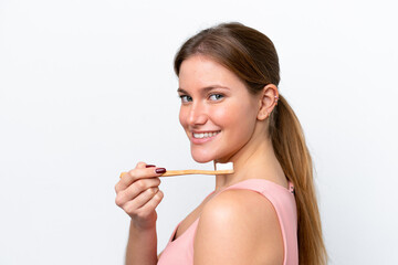 Young caucasian woman isolated on white background with a toothbrush and happy expression