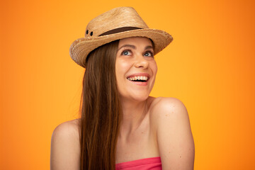 Smiling woman in straw hat looking up, face girl portrait isolated over orange yellow background.