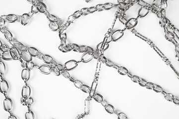 Metal chains isolated on white background top view. The concept of strength and power