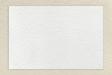 Texture of craft white paper background with light beige border, macro. Structure of vintage dense...