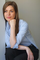 Woman sitting on chair resting, focused and thinking.