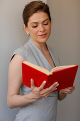 Happy woman teacher read open book. Teacher profession portrait.