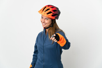 Middle age cyclist woman isolated on white background pointing front with happy expression