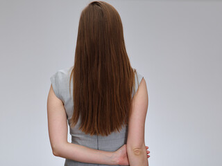 Obraz premium Woman back standing with long hair wearing business dress, isolated portrait.