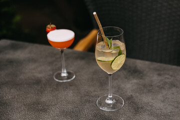 Two cocktails on a restaurant terrace table.