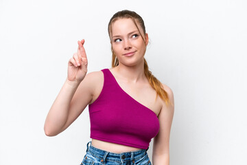 Young caucasian girl isolated on white background with fingers crossing and wishing the best