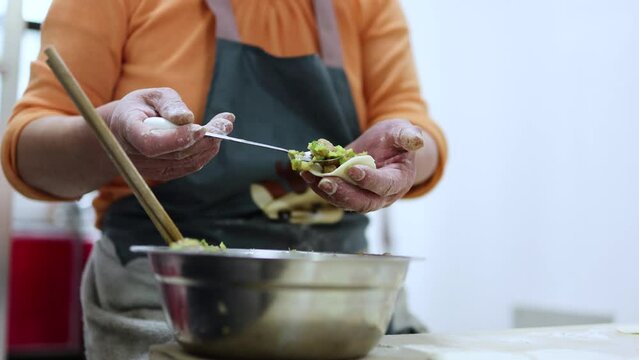 Mother makes dumplings at home