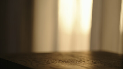 black wood table with sunset light on background