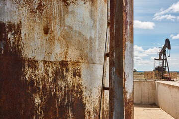 Rusty oil pumping machine. Pump jack. Petroleum extraction. Global warming