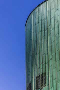 Modern Green Office Building With Blue Sky