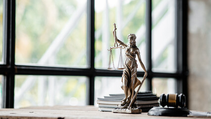 A statue of the goddess of justice is placed on the table in the judge's office, preserving law and...