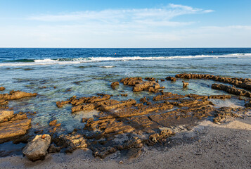 Beautiful seascape of Red Sea near Marsa Alam, Egypt, Africa. The waves breaking on the coral reef and the cliff.